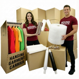 Two people with moving supplies including boxes and packaging materials.